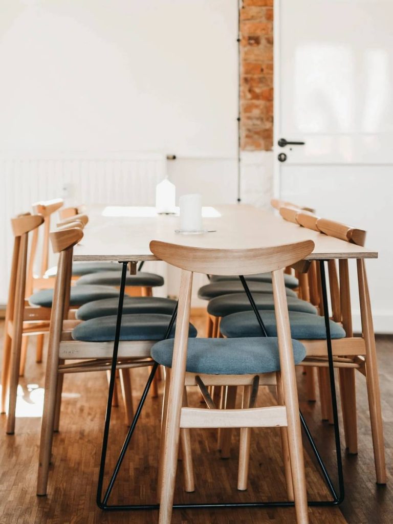 A woman sitting at the table with her laptop.